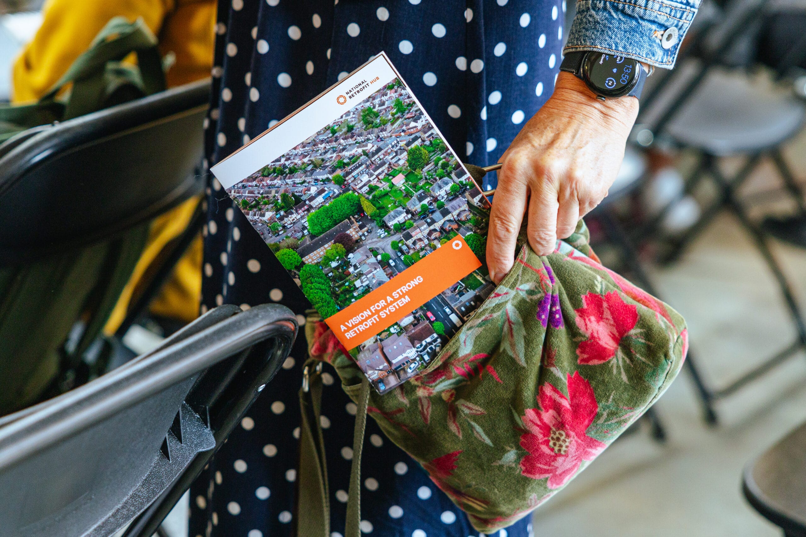 Woman holding copy of NRH report